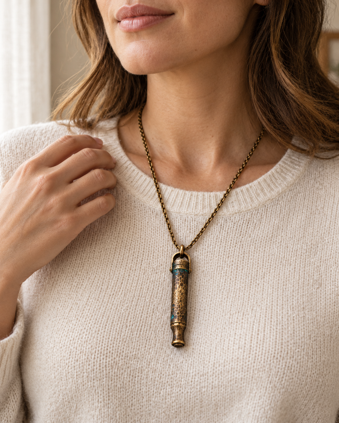 Woman wearing the Zen Anchor necklace over a cream sweater